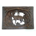 A 20thC Black Forest style carved wooden panel with openwork detail, depicting a woodland scene with
