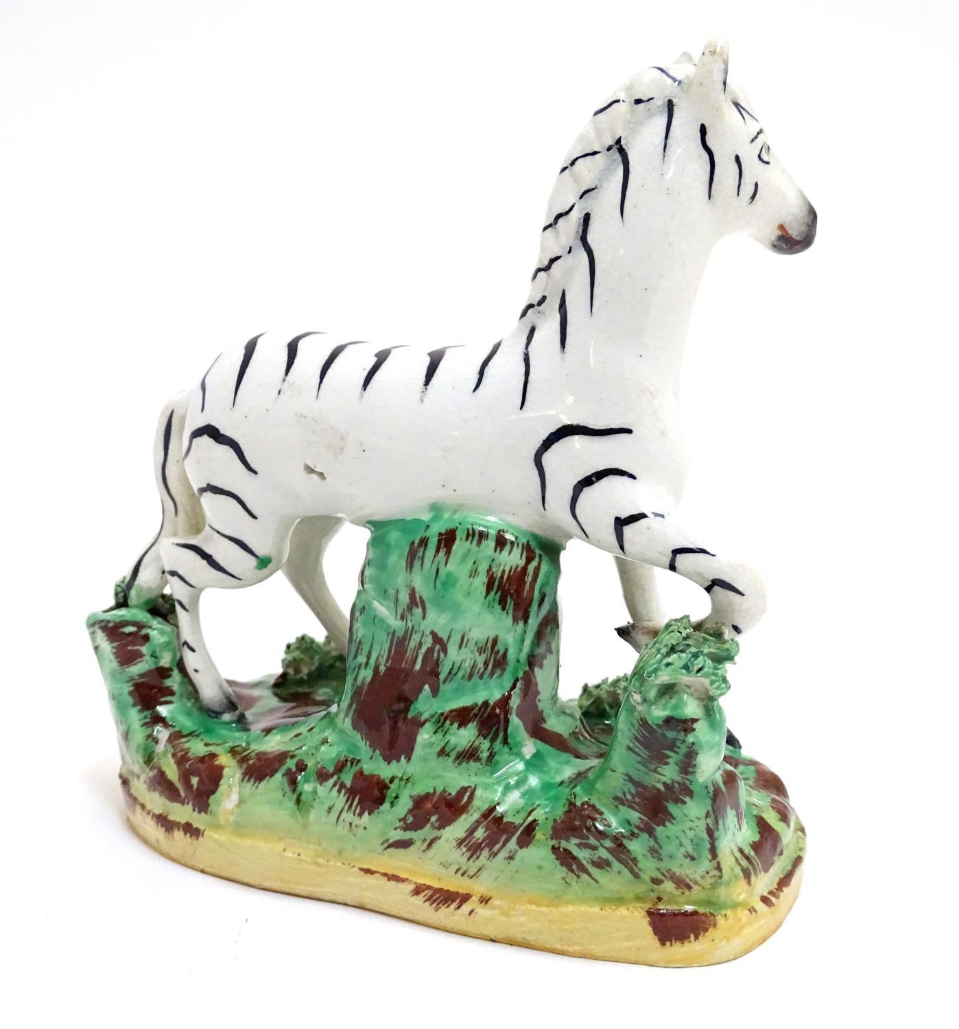 A Staffordshire figure modelled as a zebra on a naturalistic oval base. Approx. 4 3/4" high Please - Image 4 of 6