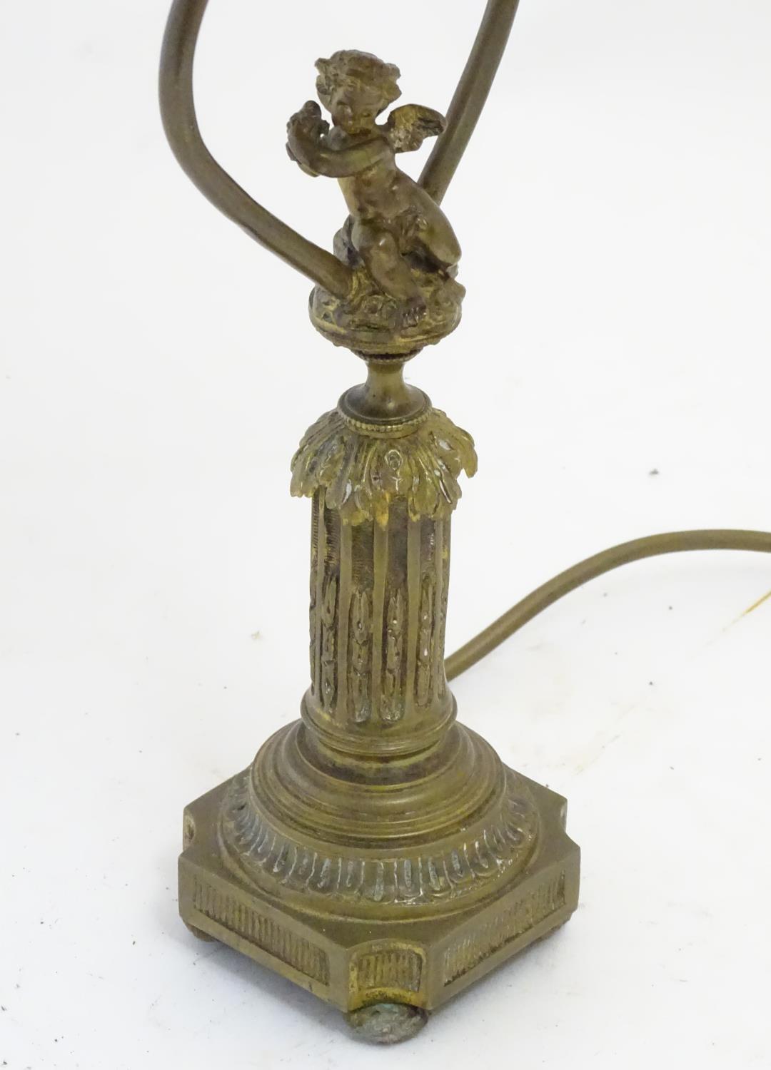 A mid to late 20thC brass table lamp, formed as a Corinthian column surmounted by a putto. 22" - Image 6 of 6