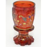 A 19thC bohemian wine glass decorated with floral decoration and gilt highlights. 5 5/8" tall Please