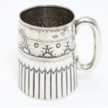 A Victorian silver mug with embossed decoration and a loop handle. Hallmarked Birmingham 1895