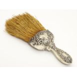 A brush with white metal handle having embossed decoration 8" long Please Note - we do not make