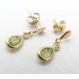 A pair of 9ct gold drop earrings set with peridot drops. Approx 3/4" long Please Note - we do not