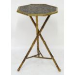 A late 19thC Meiji period occasional table with an octagonal top having a embossed gilt surface
