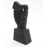 A 19thC Irish bog oak carved harp with shamrock decoration on a tapering base inscribed Erin.