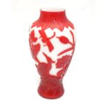 A Peking glass baluster vase with overlaid decoration depicting birds, dragonflies etc. 11" tall