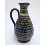 A Doulton Lambeth stoneware jug / ewer with relief decoration. Impressed marks under, maker HW