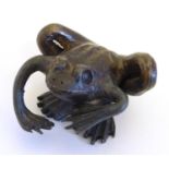 A naive bronze model of a frog. Approx. 1 1/2" high Please Note - we do not make reference to the
