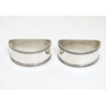 A pair of silver napkin rings of semi circular form hallmarked Birmingham 1932 maker E & N Speak