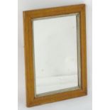 An early 20thC mirror with a birdseye maple frame and a painted surround. Measuring 17" wide x 22"