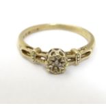 A 9ct gold ring set with central diamond. Ring size approx K Please Note - we do not make