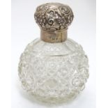 A cut glass scent bottle of spherical form with silver mounts and top hallmarked Birmingham 1899