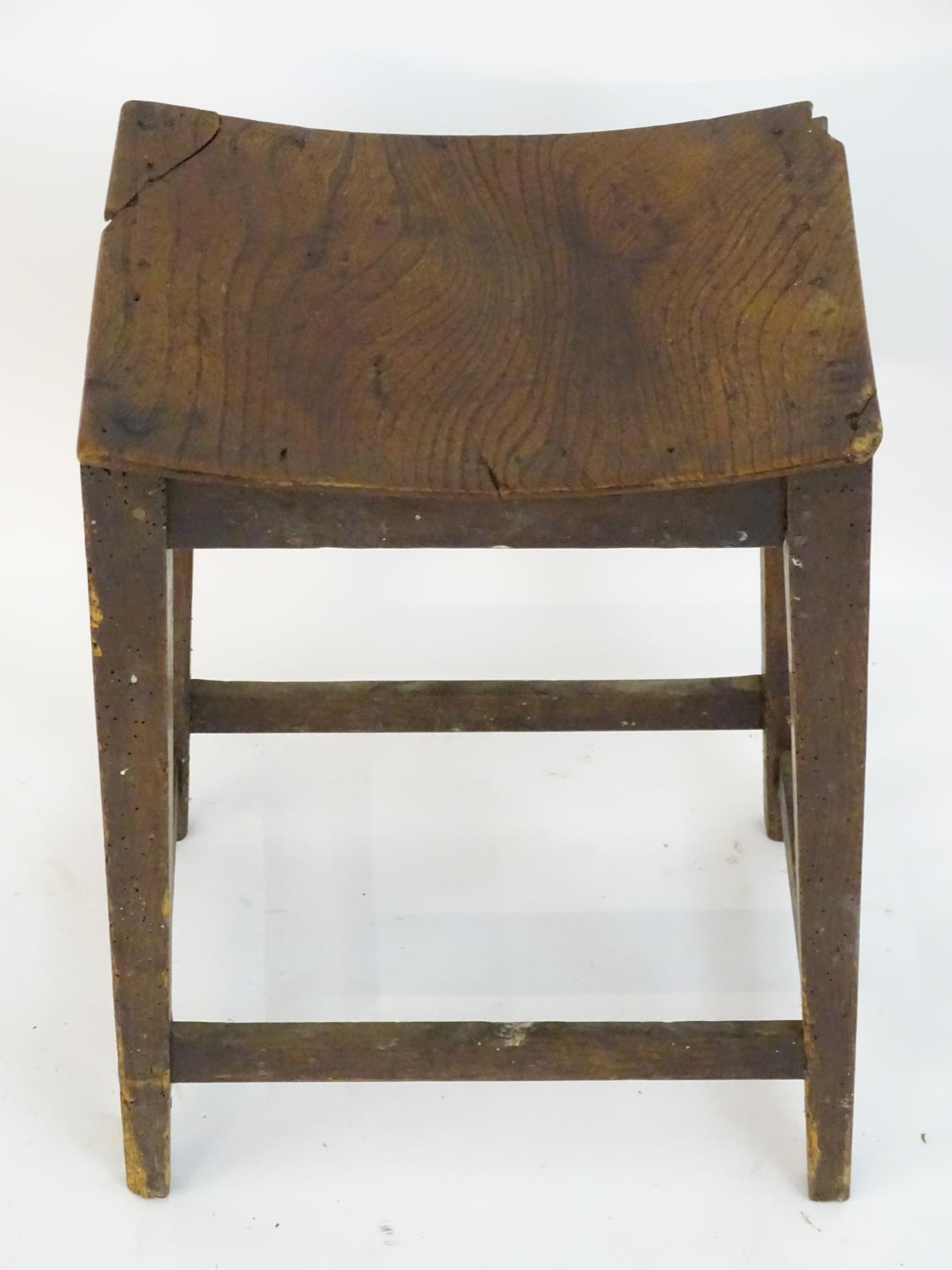 An 18thC elm stool with a bowed top above squared tapering legs and united by a box stretcher. 14? - Image 3 of 4