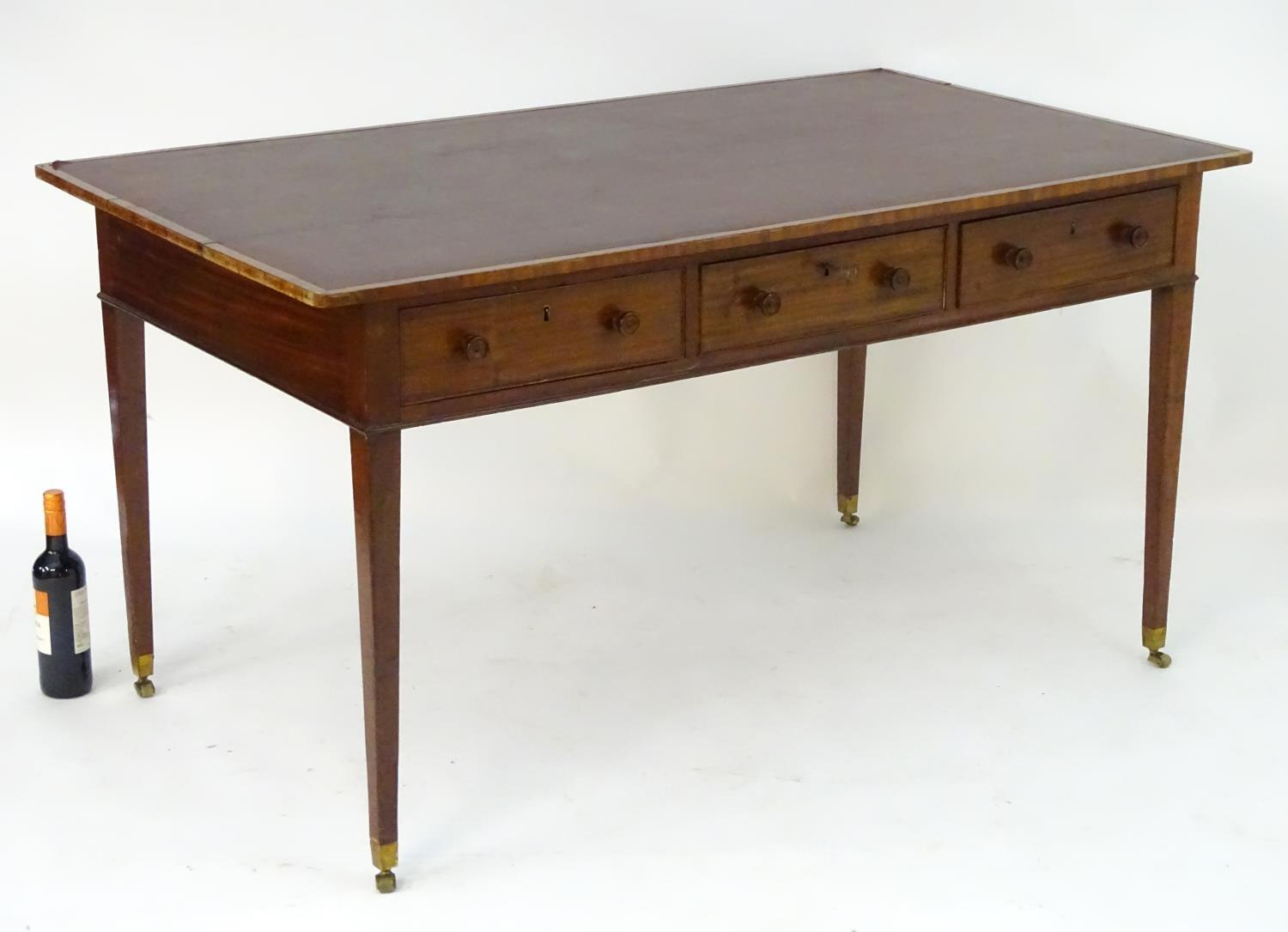 A late 18thC / early 19thC mahogany writing table with an inset top above three short drawers and - Image 3 of 7