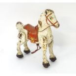 A mid 20thC Mobo 'Bronco' tinplate/pressed metal toy horse, 27" tall, 30" long, 13" wide Please Note