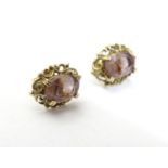 A pair of 9ct gold stud earrings set with amethyst. Approx 1/4" Please Note - we do not make
