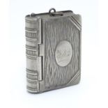 A silver plate vesta / stamp case formed as a book 2" high x 1 3/4" Please Note - we do not make