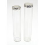 Two silver lidded glass vanity bottles. Hallmarked London 1910 maker Charles Fox & Co Ltd and London