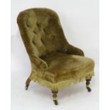 A late 19thC chair with button back upholstery and sprung seat above four mahogany legs