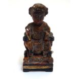 A Chinese wood and gesso joss figure with polychrome decoration. Character marks verso. Approx. 5