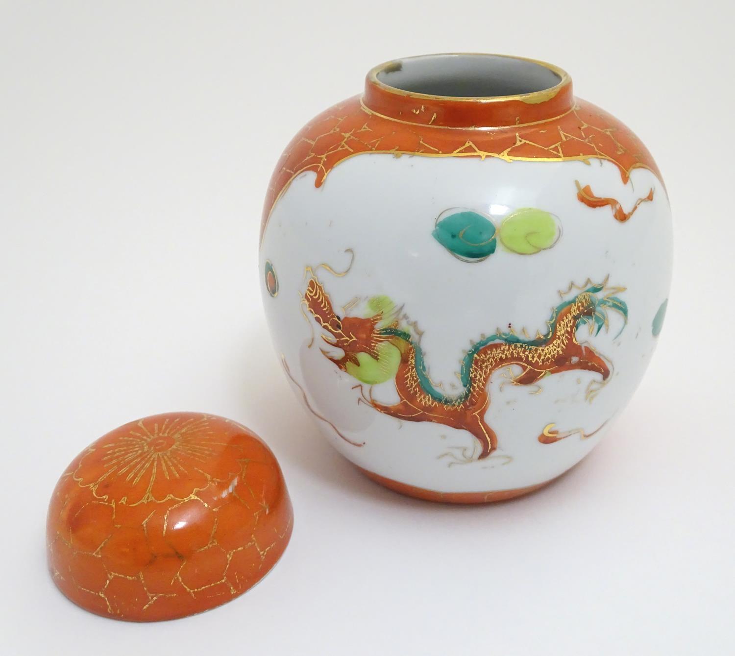 An Oriental ginger jar with hand painted decoration with lobed panels depicting a stylised dragon - Image 4 of 8