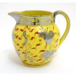A 19thC canary yellow Sunderland lustre cream jug with stylised lustre leaf and foliate