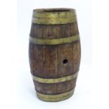 A late 19thC / early 20thC coopered barrel with brass banding. Measuring 13" wide x 10" deep x 23"