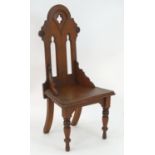 A late 19thC pine Gothic chair with pierced quatrefoil detailing and lancet shaped detailing, the