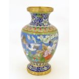 A 20thC Chinese cloisonne vase of baluster form, decorated with crane birds, flowers to include