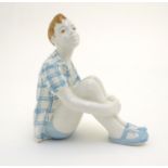 A Russian figure modelled as a seated boy / dreamer. Marked under. Approx. 4 1/2" high Please Note -