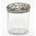 A glass toilet bottle with silver lid hallmarked London 1893 maker Charles Henry Dumenil 3 1/5" high