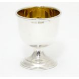 A silver egg cup with gilded interior and weighted base. Hallmarked Birmingham 1963 maker Angora