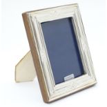An easel back photograph frame with silver surround hallmarked London 2017maker Highfield Frames.