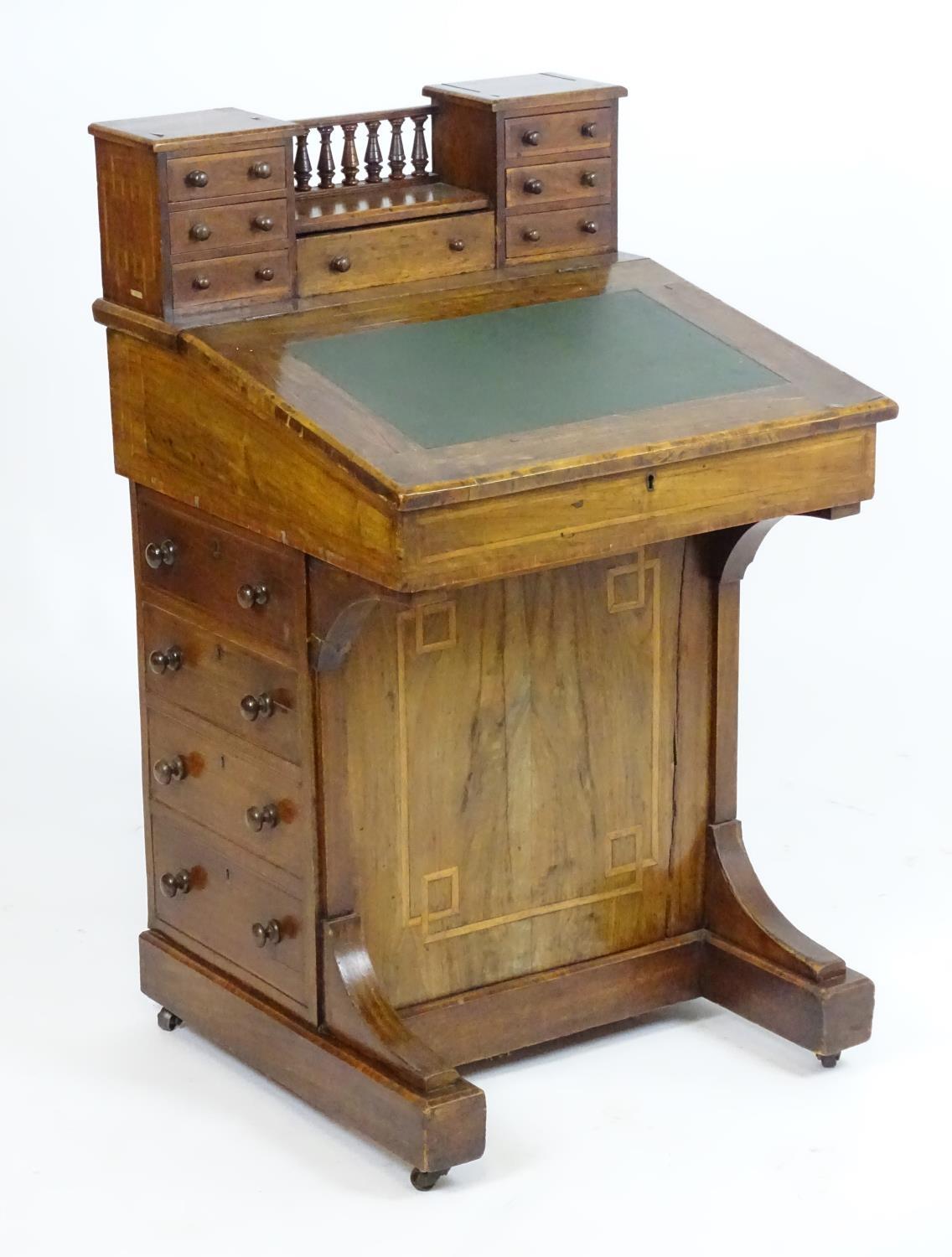 A mid / late 19thC walnut davenport with two banks of three short drawers together with a central