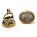 A gilt metal pendant fob seal with seal under depicting a male head. 1" high Please Note - we do not
