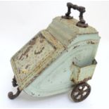 A Victorian tin coal scuttle, the base with wheels and stand, 21" deep, 12" wide, 17" tall Please