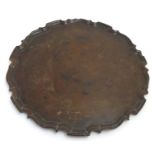 A 19thC mahogany tray of circular form with pie crust rim. Approx. 20 1/4" diameter Please Note - we