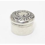 A small silver box of circular form with embossed decoration to lid. Hallmarked Birmingham 1902