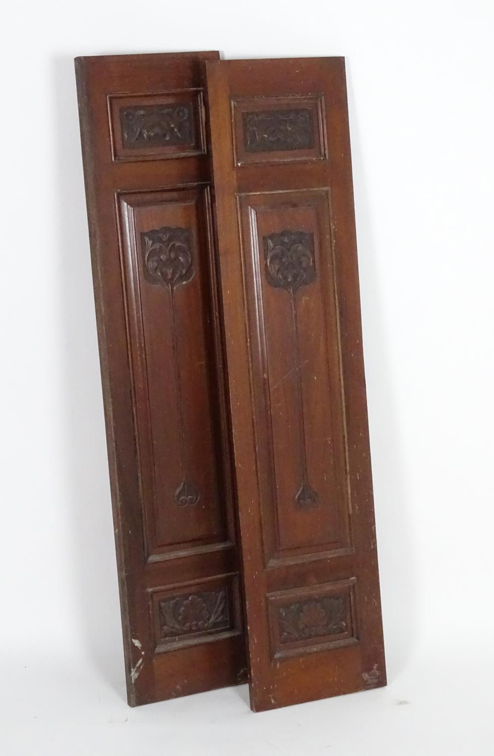 A pair of early 20thC mahogany panels with carved Art Nouveau decoration. 13" wide x 55" high.