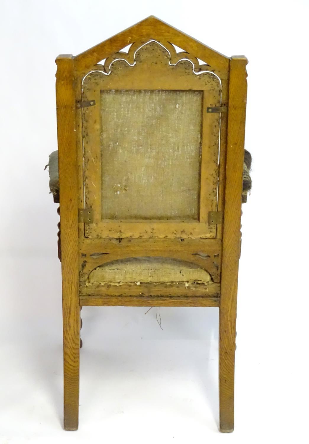 A mid / late 19thC oak armchair with a pointed pierced cresting rail, moulded frame and raised on - Bild 2 aus 6