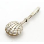 A white metal napkin clip with scallop shell formed grips. 2" long Please Note - we do not make