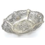 A Continental silver dish of basket form with lattice decoration and cast cherub scene. 7 1/4"