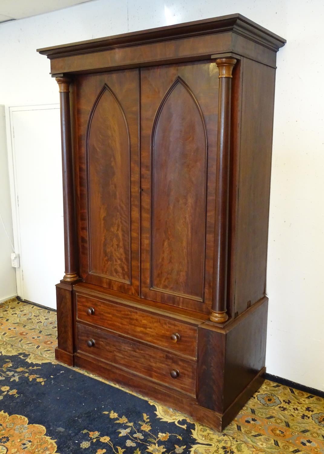 A 19thC mahogany press with a moulded cornice above two large doors with lancet shaped panelling, - Bild 4 aus 7