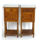 A pair of late 19thC / early 20thC pine bedside cabinets with inset marble tops, each cabinet having