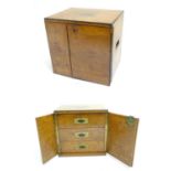 A small late 19thC oak and walnut cased military campaign chest with twin brass recessed handles,