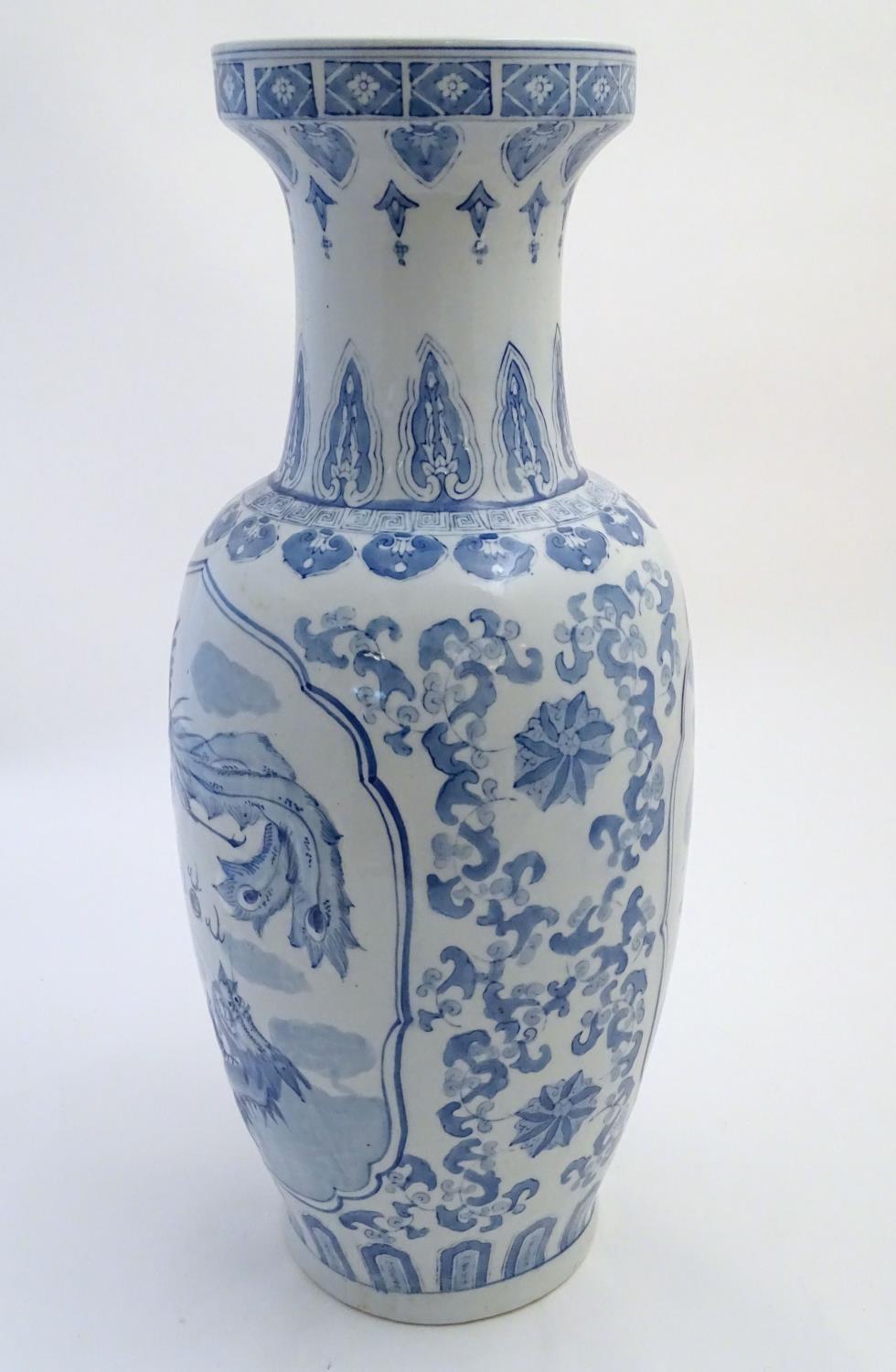 A large Chinese blue and white vase decorated with flowers, foliage and a stylised phoenix and - Image 4 of 10
