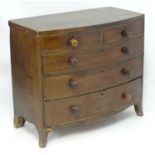 A late 18thC mahogany bow fronted chest of drawers with two short over three long drawers with