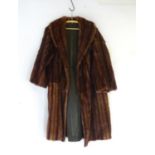 A knee length fur coat. Bust size 46" Approx Please Note - we do not make reference to the condition