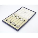 A cased set of 6 silver coffee spoons with coffee bean decoration to handles. Hallmarked