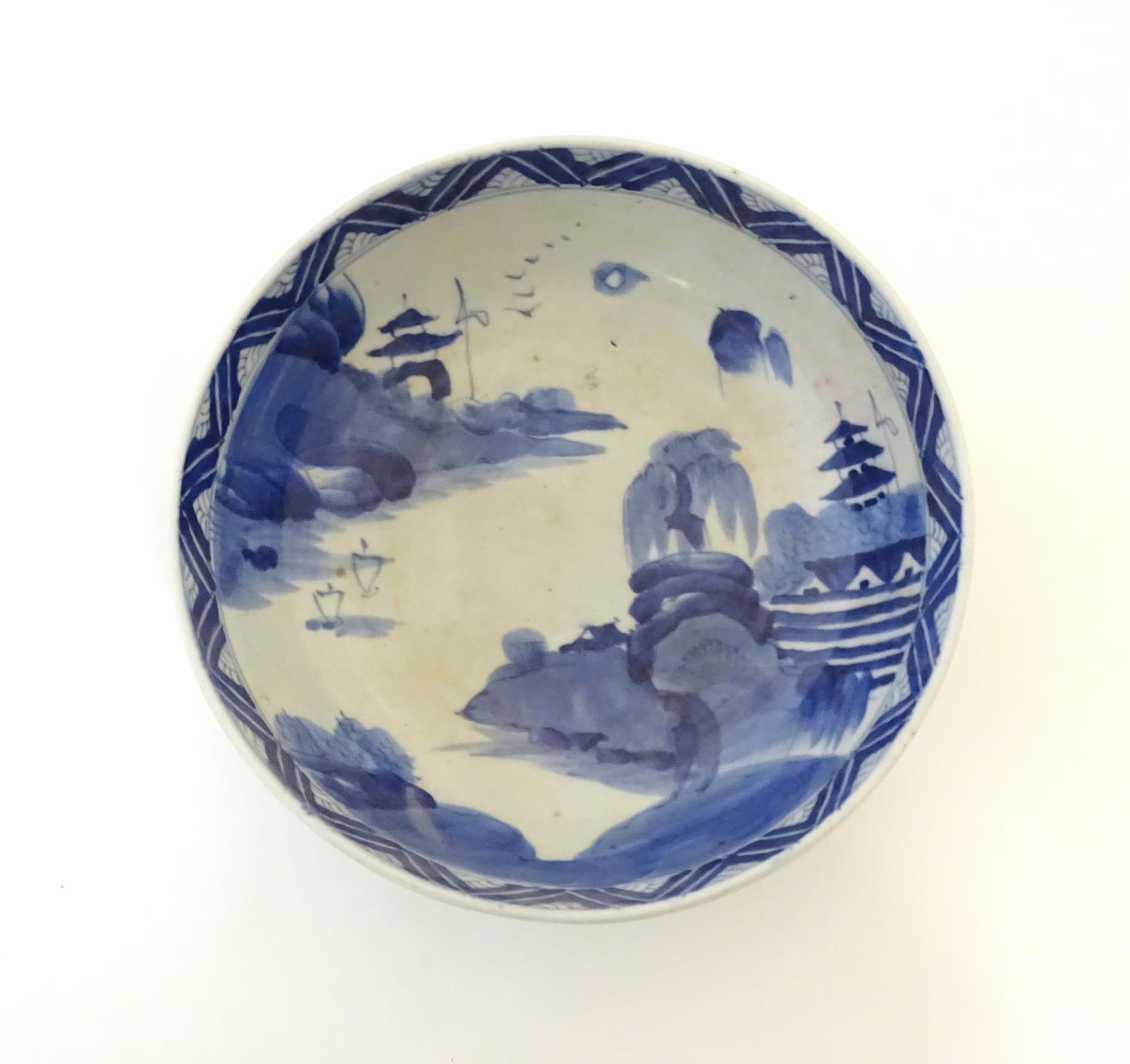 A Chinese blue and white bowl with hand painted decoration depicting an Oriental landscape with - Image 8 of 10